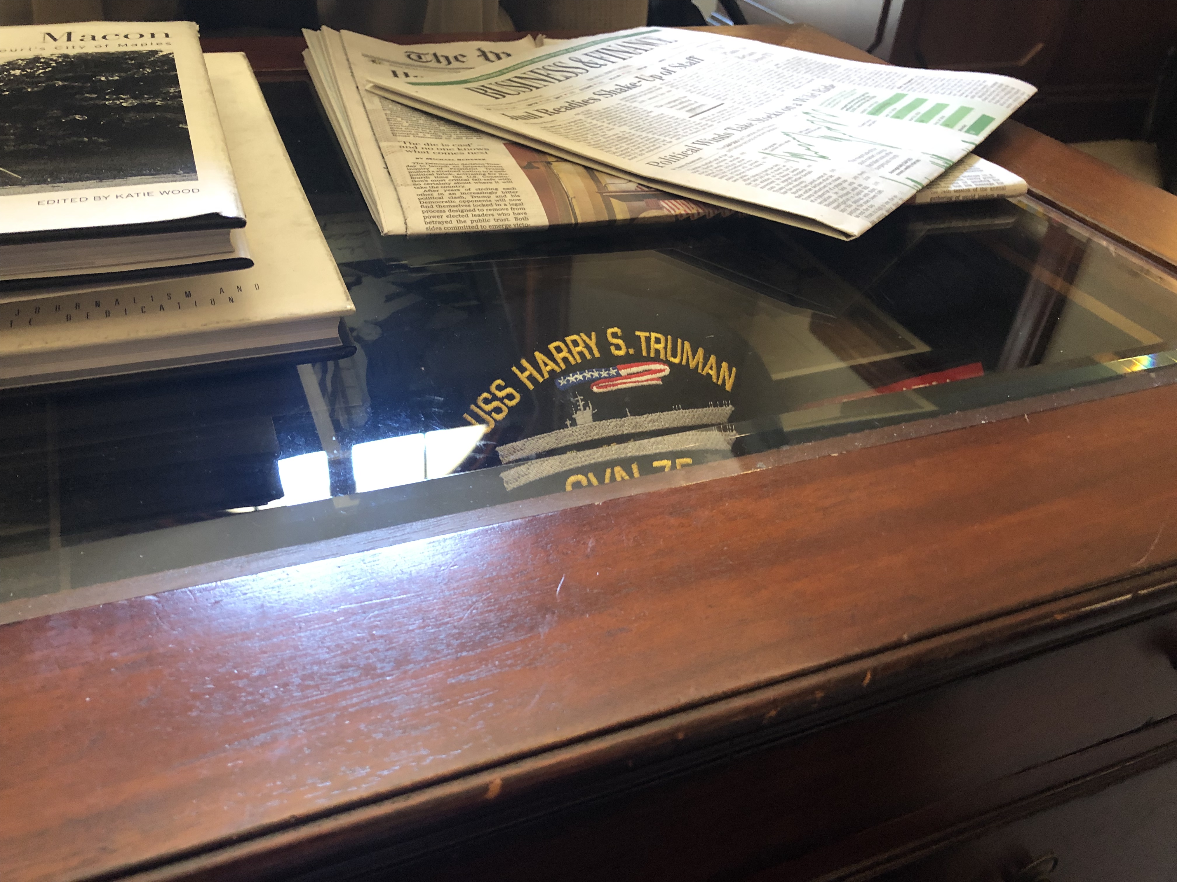 USS Harry Truman hat inside a coffee table with a class top